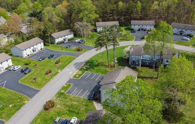 an aerial view of a neighborhood of houses with cars parked