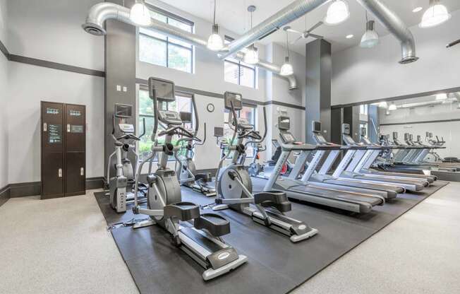 a room filled with cardio equipment and weights