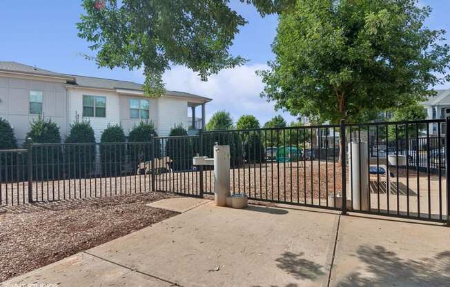 our apartments have a fenced in yard with a playground and trees