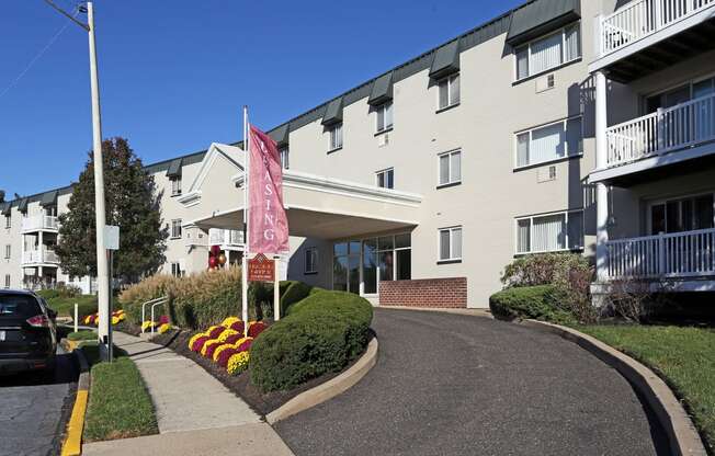 an apartment building with a pink flag in front of it