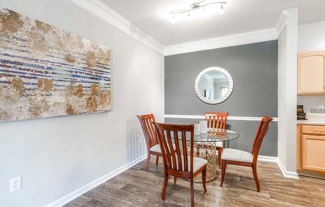 A dining room with a table set for four.