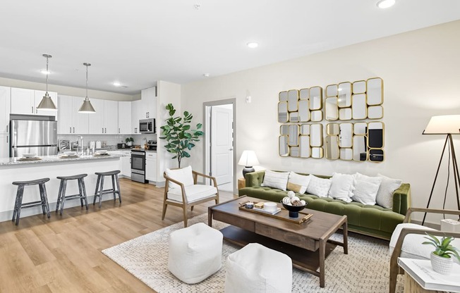 A modern living room with a green couch and a wooden coffee table.
