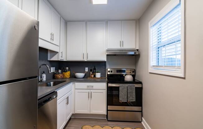 Renovated Kitchen with stainless steel appliances and quartz countertops at Elme Sandy Springs Apartments, Atlanta, GA