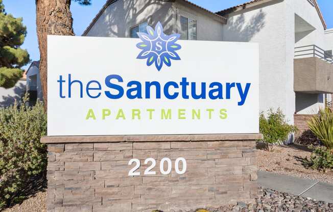 a picture of the sign at the sanctuary apartments in grand prairie, tx