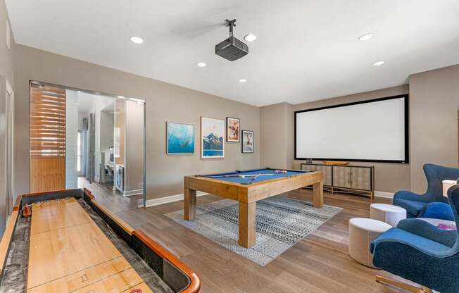 The clubhouse offers a variety of amenities, including a rec room with a pool table, TV, and shuffleboard—perfect for relaxing and socializing at Ascent at the Galleria.
