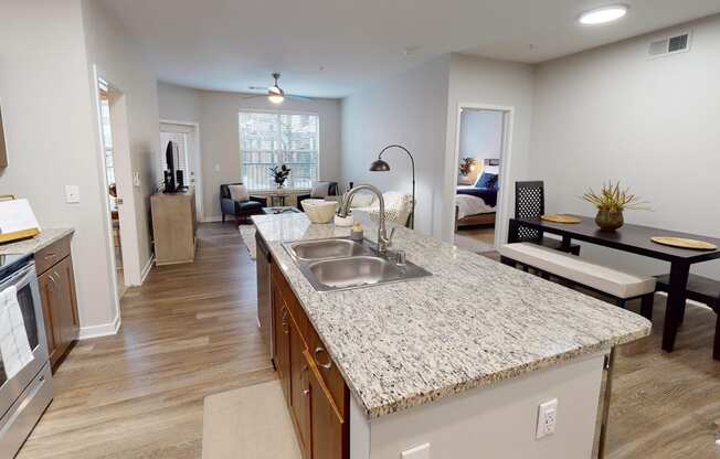 an open kitchen and living room with a granite counter top