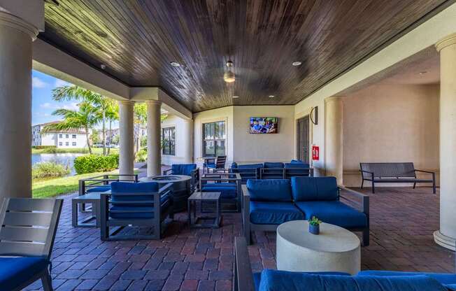 A patio with blue couches and chairs is shown.