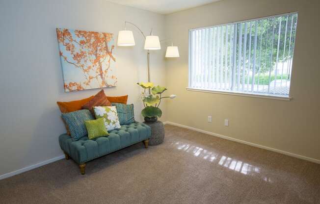 Model living room with a couch and a window