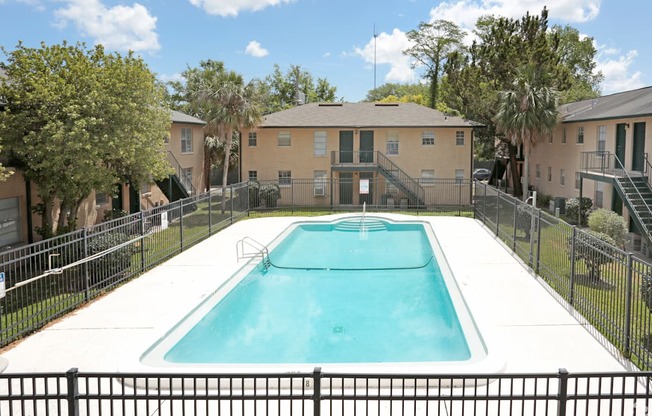 A swimming pool surrounded by a black fence.