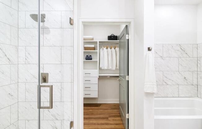 A penthouse bath that flows directly into a custom closet, designed for easy mornings and streamlined storage.
