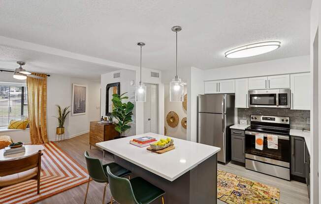 A modern kitchen with a dining table and chairs.