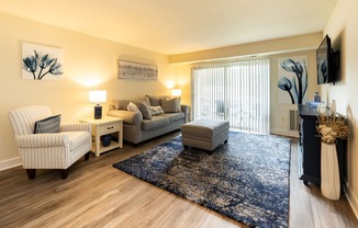 Living room with a couch, a chair, a rug, and décor in Randallstown, MD 21133.