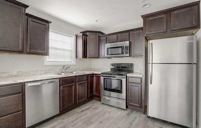 Kitchen with stainless steel appliances and wooden cabinets at Hudson Ridge, Red Lion, Pennsylvania