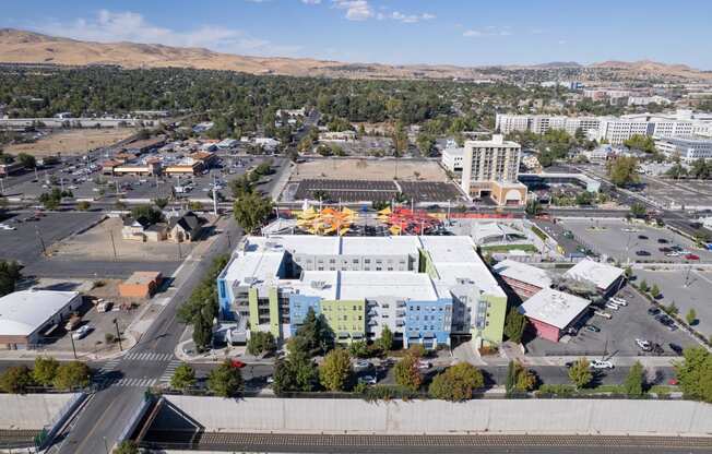 an aerial view of a city with buildings and a parking lot