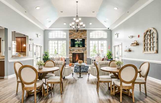A dining room with a fireplace and a chandelier.
