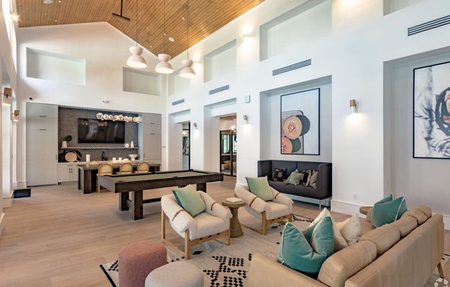 a living room filled with furniture and a large window