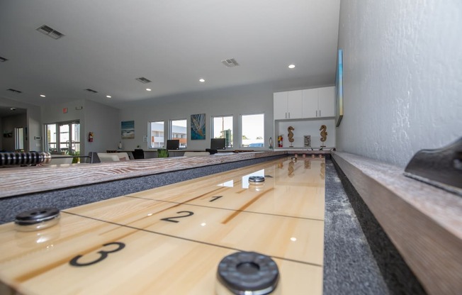 a bowling alley with wood lanes and numbers on the floor