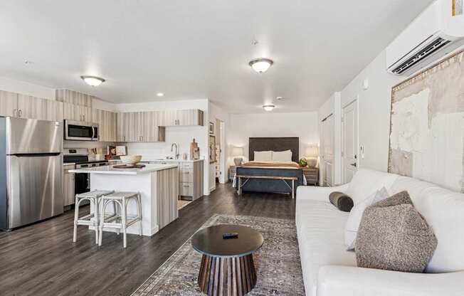 A modern kitchen with a white couch and a coffee table.