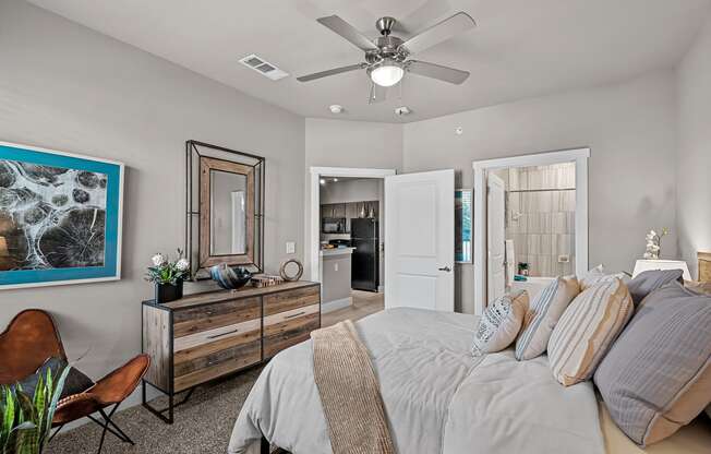 a bedroom with a large bed and a ceiling fan