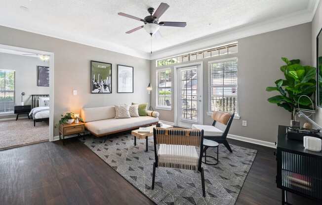 living room with patio door and large windows  at Sugarloaf Crossings Apartments in Lawrenceville, GA 30046