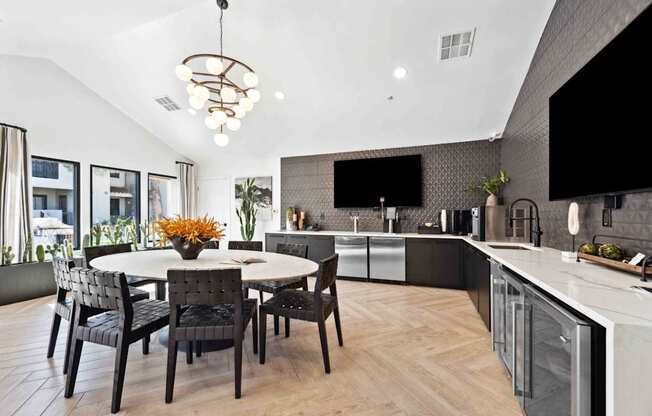 A modern kitchen with a dining table and chairs.