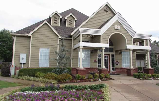 a house with a flower garden in front of it at GABLE HILLS Apartments, TULSA ,74127