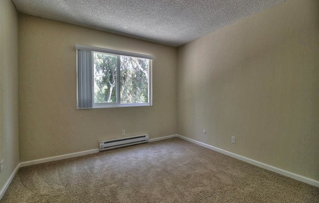 Bedroom with window and wooden floor at Boardwalk, California