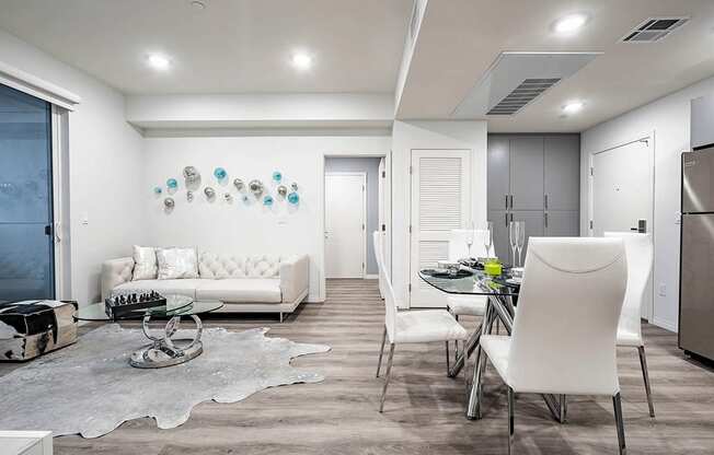 Living room and dining area with recessed lighting, wood style flooring throughout