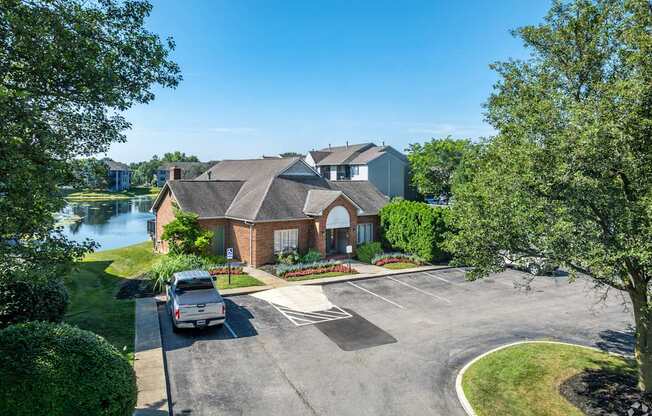 A house with a driveway and a car parked in front.