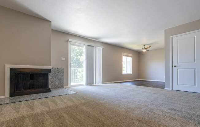 Open Living and Dining Room with Patio Access in the Two Bedroom One Bath Apartment at Woodbridge Apartments Bloomington
