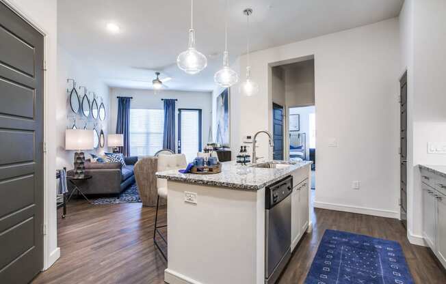 a kitchen with an island and a living room