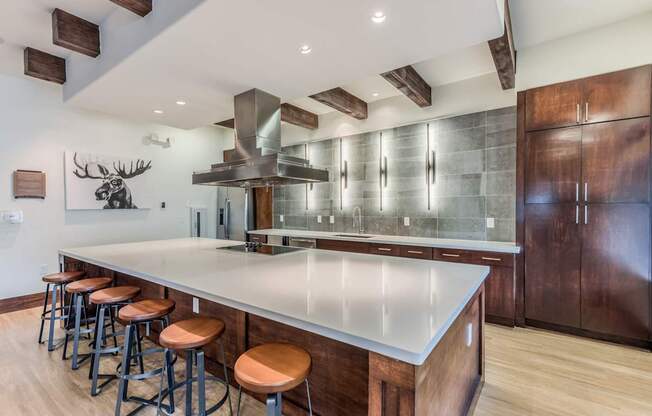 A modern kitchen with a large island and wooden cabinets.