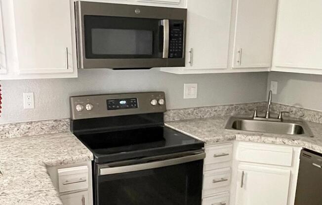 a kitchen with a microwave oven sitting on top of a stove