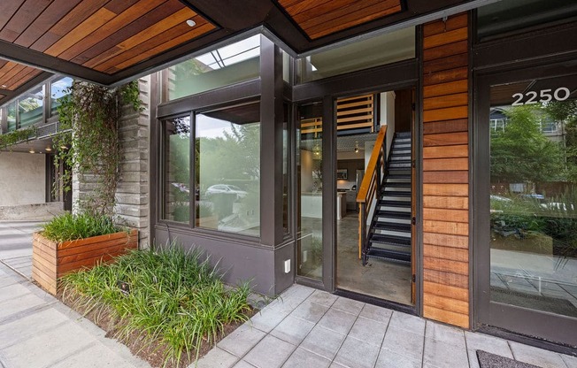 A modern building with a wooden facade and a glass door.