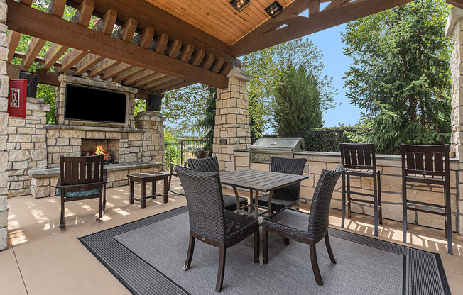 a patio with chairs and a fireplace