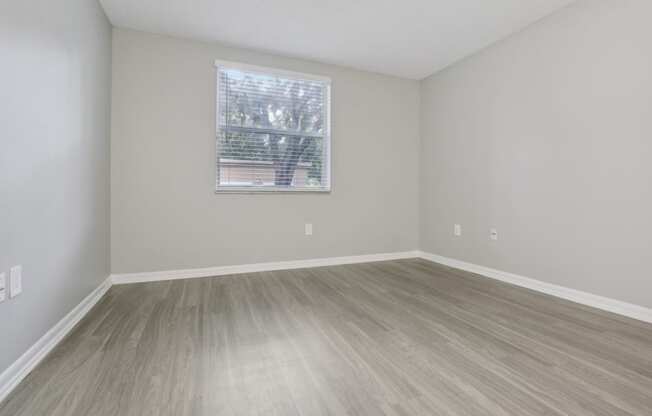 an empty room with wood floors and a window at Pembroke Pines Landings, Florida