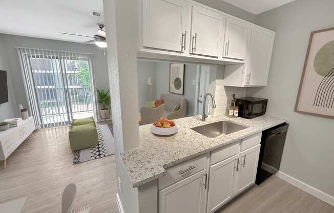 a kitchen with white cabinets and a granite counter top