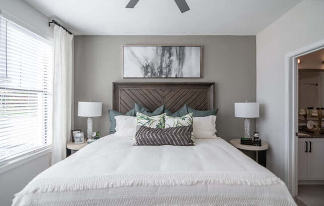 a bedroom with a large bed and a ceiling fan