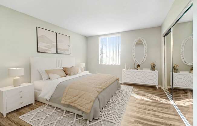 a bedroom with a bed and a mirrored closet