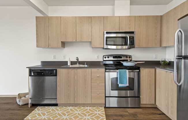 a kitchen with wooden cabinets and stainless steel appliances