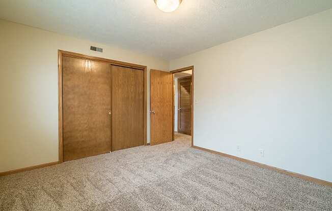 Spacious bedroom with closet space at Fountain Glen Apartments