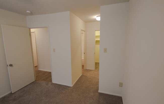 This is a photo looking towards the primary bathroom and walk-in closet in the primary bedroom in a 849 square foot 2 bedroom, 2 bath apartment at Park Lane Apartments in Cincinnati, OH.