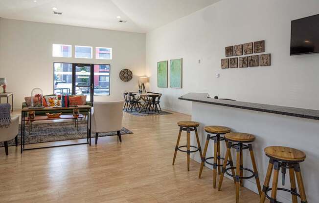 A room with a bar and stools.