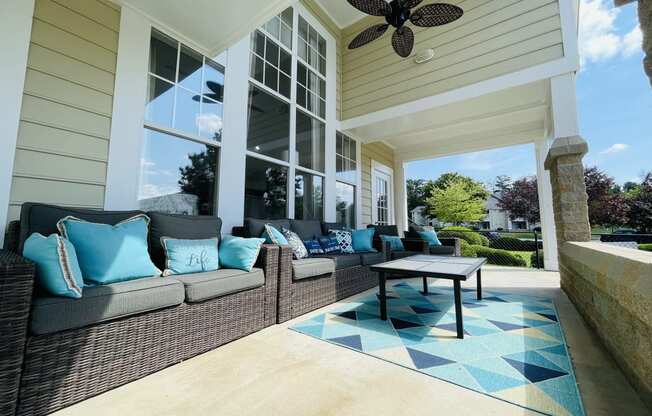 Covered porch with couches and a coffee table at The Chase, North Carolina