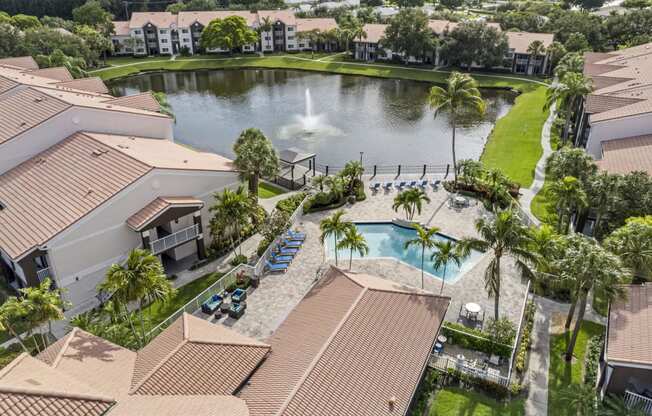 an aerial view of a house with a pool and a fountain