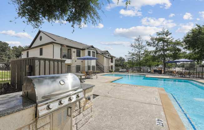 the preserve at ballantyne commons pool and clubhouse with a grill and a pool