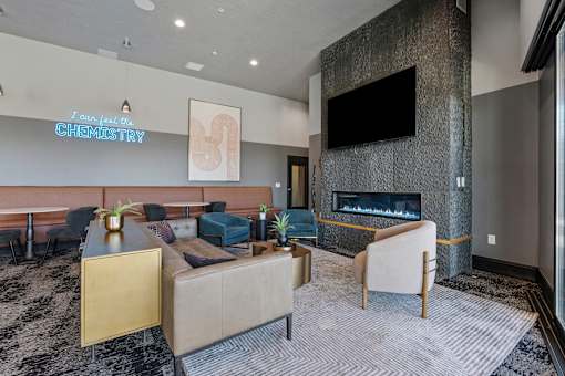a living room with couches and chairs and a fireplace at SevenO2 Main Apartments, Salt Lake City