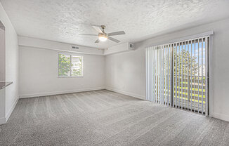 enlarged living room with ceiling fan at The Crossings Apartments, Michigan, 49508