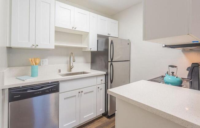 a kitchen with white cabinets and a stainless steel refrigerator  at Skyline Heights LLC, California, 94015