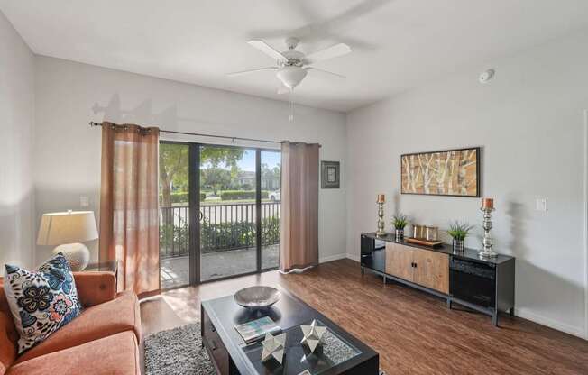 A living room with a brown couch and a black coffee table.